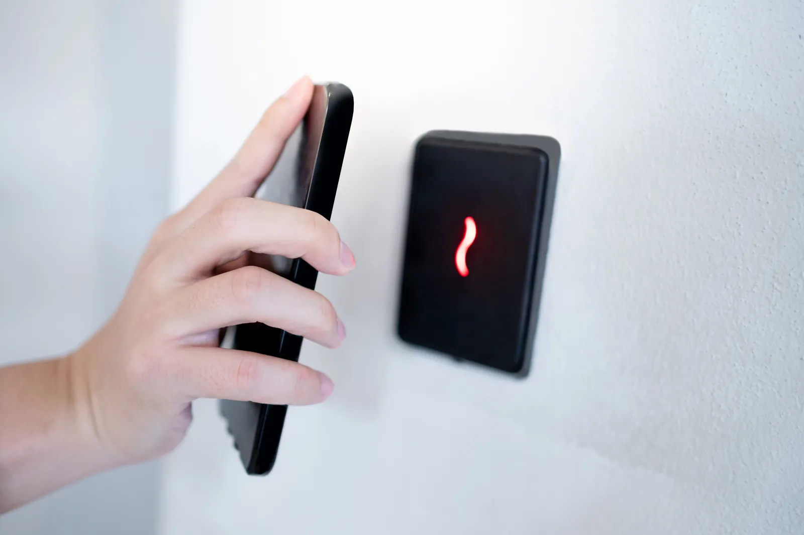 Phone presented to a wall-mounted access reader